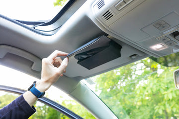 Person opening sunglasses case attached to car's visor geckobrands