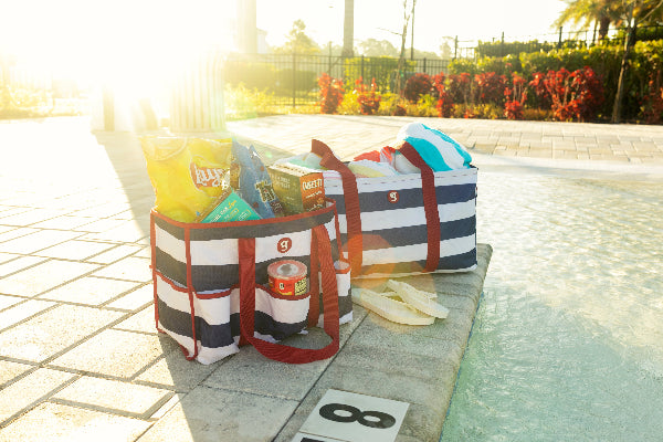 Stripped bags with snacks by a poolside