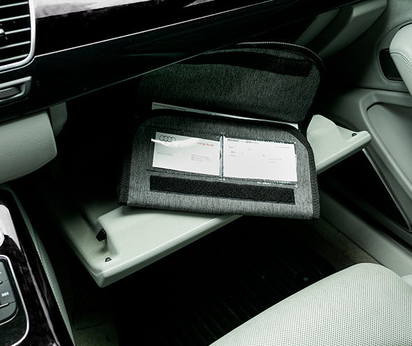 Grey fabric organizer pouch inside car's glove compartment open to display two ID card windows