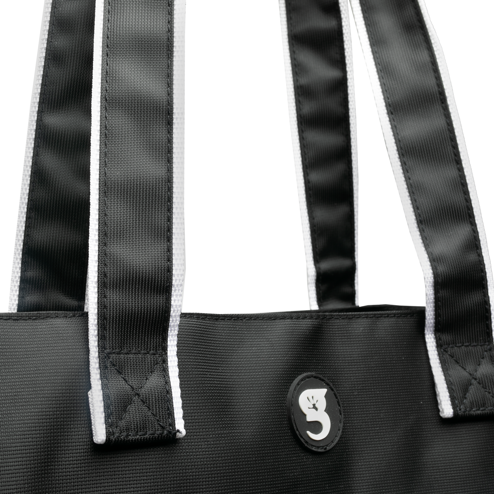 Black and white tote bag with white straps and a logo on a white background