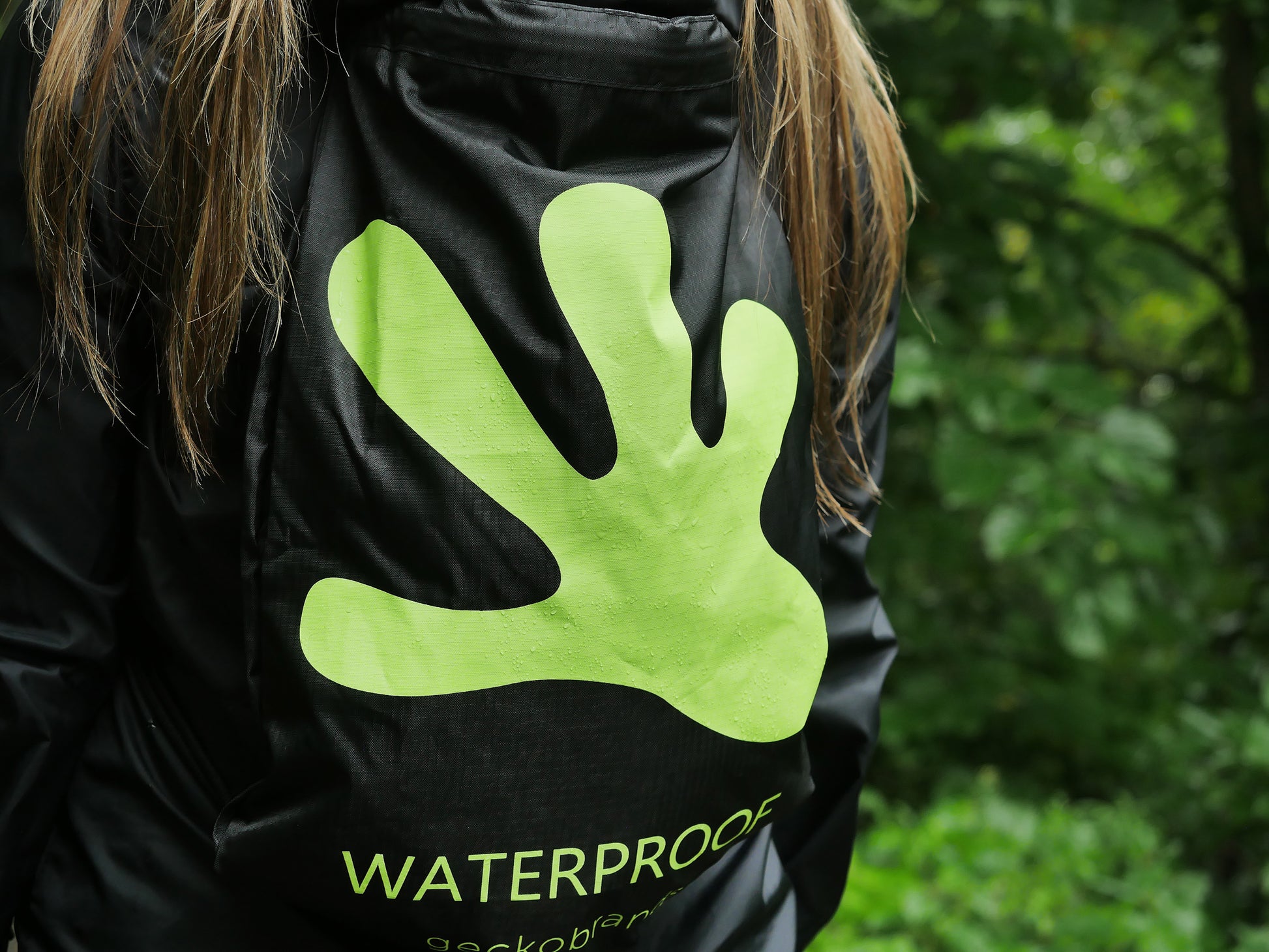 GWP-13891BG
Person wearing a black jacket with a green hand-shaped logo and 'Waterproof' text, against a blurred green background.