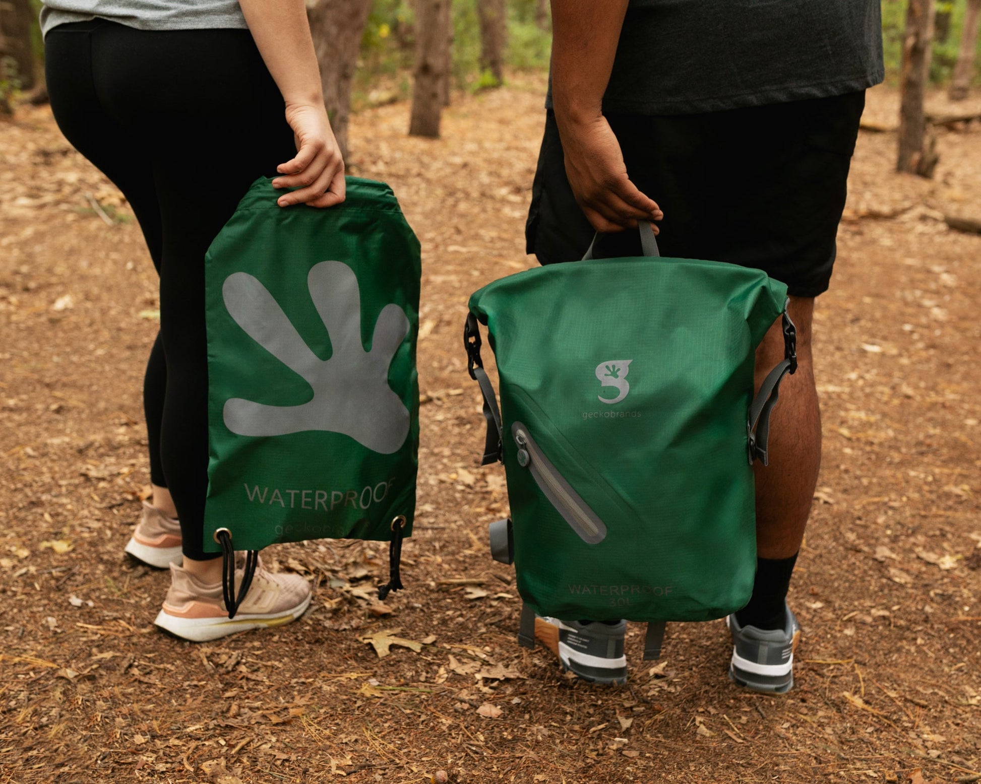 GWP-17578HG
Two people holding green outdoor bags with visible branding in a forest setting.